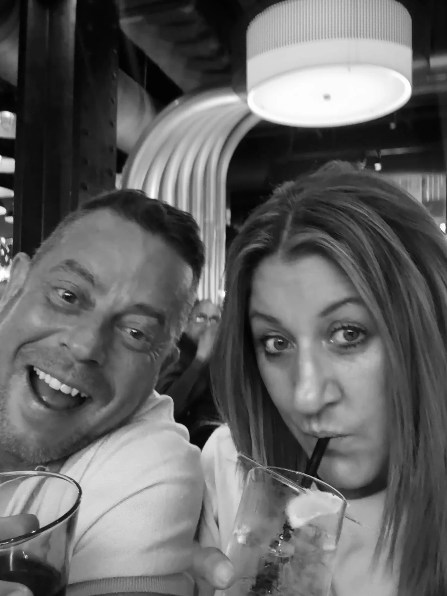 Kerri and Si sharing drinks and laughter
